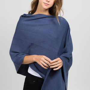 Young woman posing wearing an indigo colored poncho
