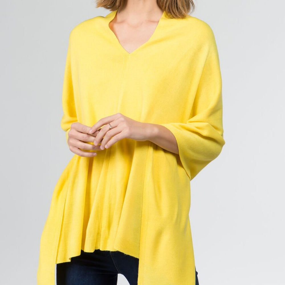 Woman wearing yellow faux cashmere poncho